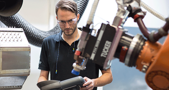 Stud welding engineer setting up an automated production line